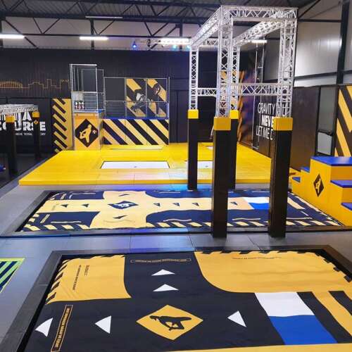 Trapeze trampoline park with airbag